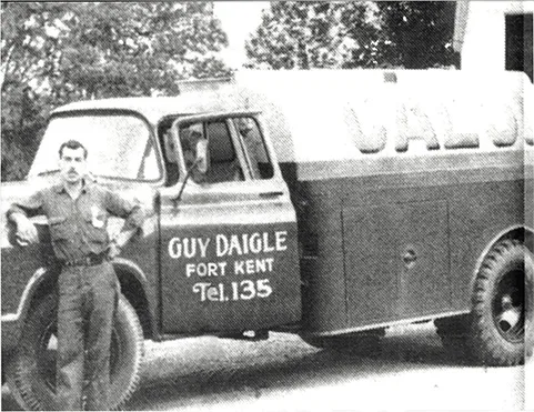 old weathered photo of the original Daigle truck and owner