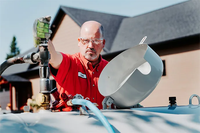 daigle fuel employee filling up a residential propane tank