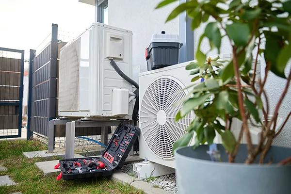 Outdoor heating and cooling equipment beside a suburban house