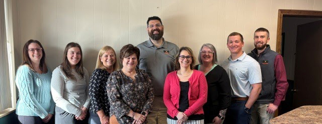 daigle employees posing for a group photo in their office