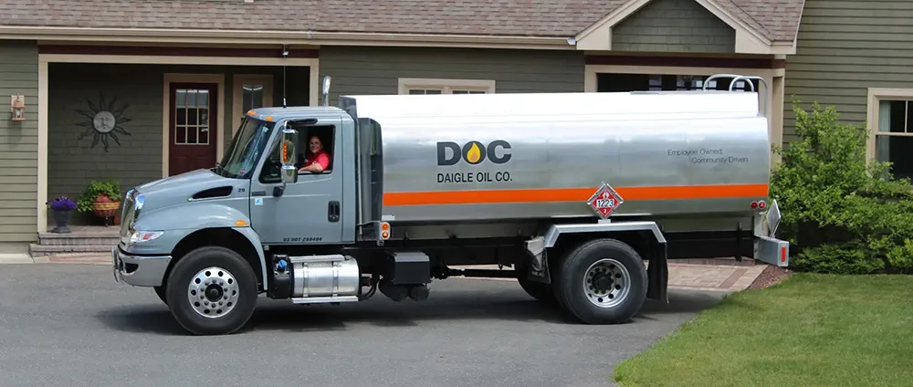 daigle employee sitting in a fuel delivery truck in a residential driveway